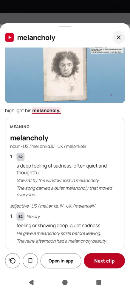 The card over another app: “melancholy” with the clip and its meaning